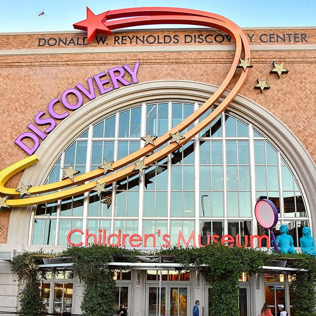 Photo of the Discovery Children's Museum building seen from street view and right in front of the entrance